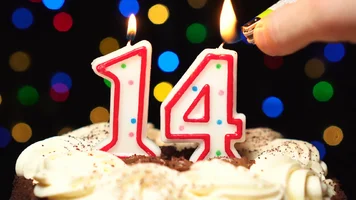 videoblocks-number-14-on-top-of-cake-fourteen-birthday-candle-burning-blow-out-at-the-end-col...webp